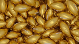 a pile of gold footballs with a football on them