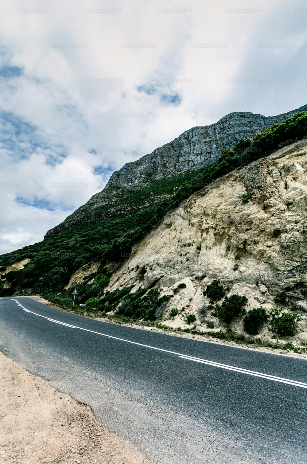 a road with a mountain in the background