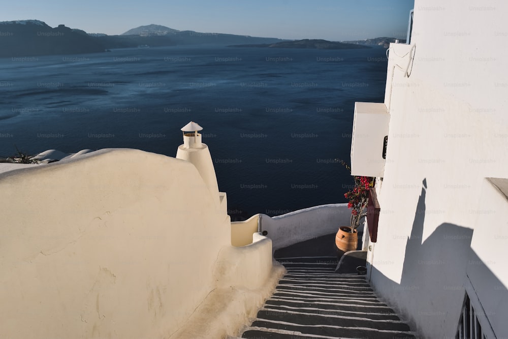 a stairway leading to a building with a view of the ocean