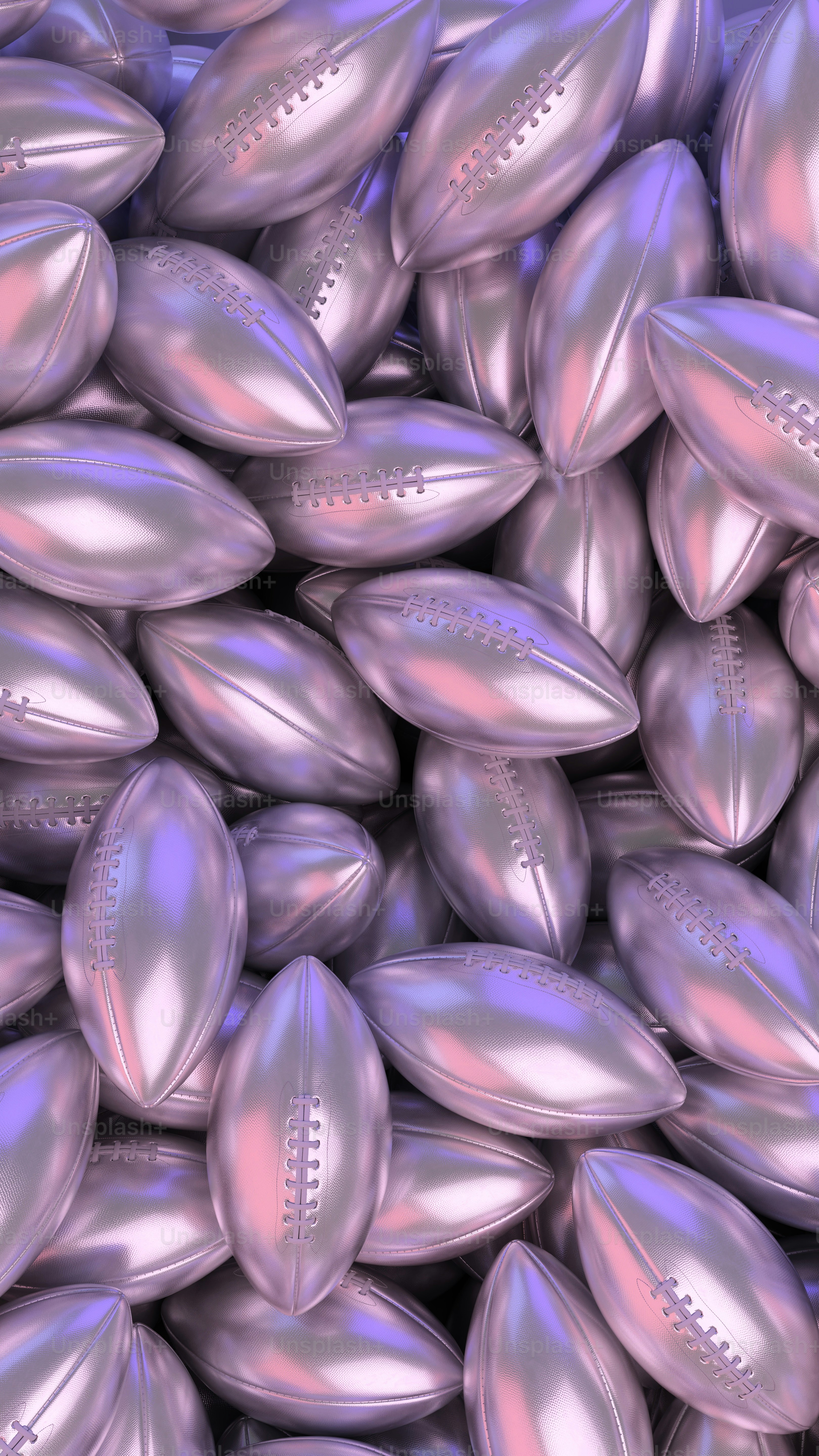 a pile of shiny silver footballs sitting on top of each other