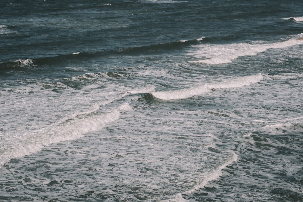 a person riding a surfboard on top of a wave