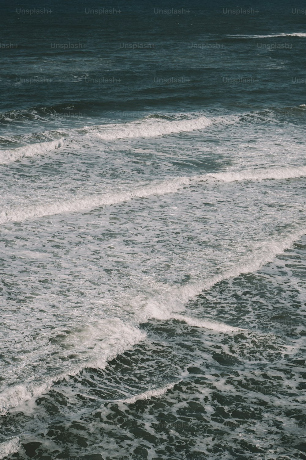 a person riding a surfboard on top of a wave