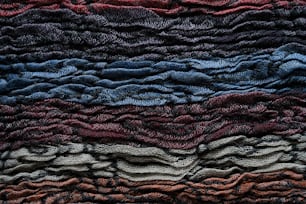 a close up of a multi colored knitted blanket