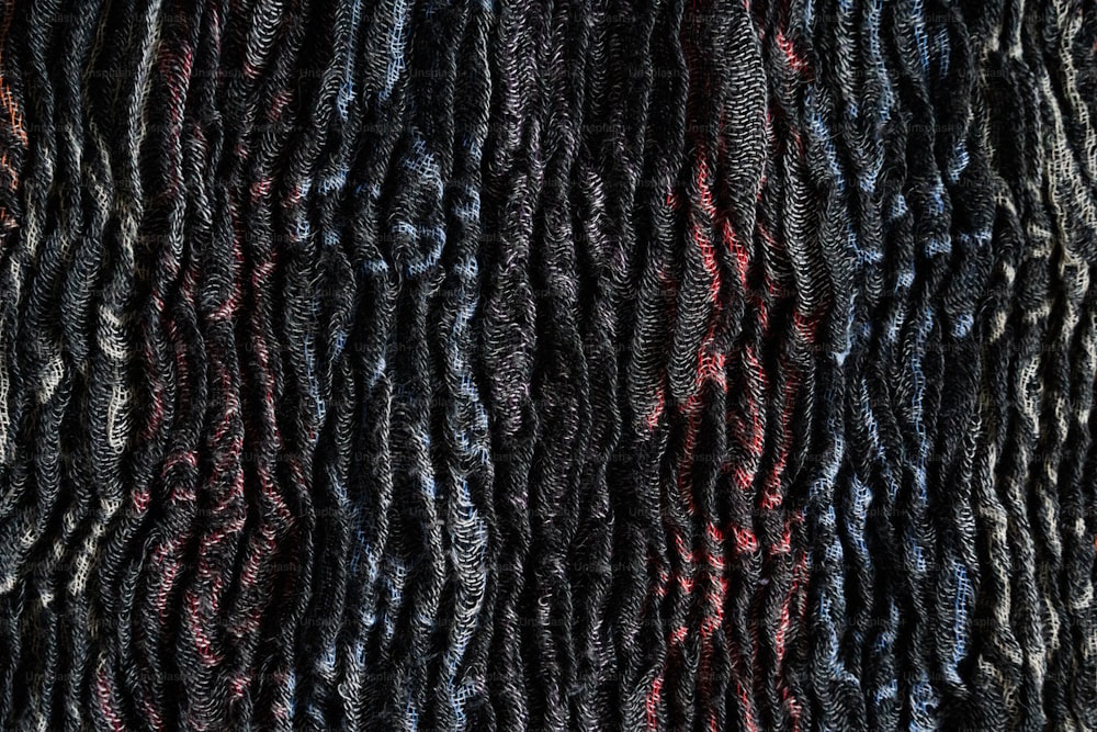 a close up of a black and red textured material
