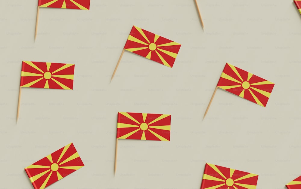 a group of red and yellow flags sitting on top of a table