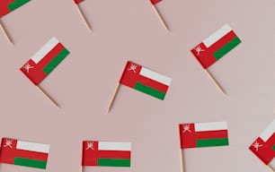 toothpicks with flags of different countries on a pink background