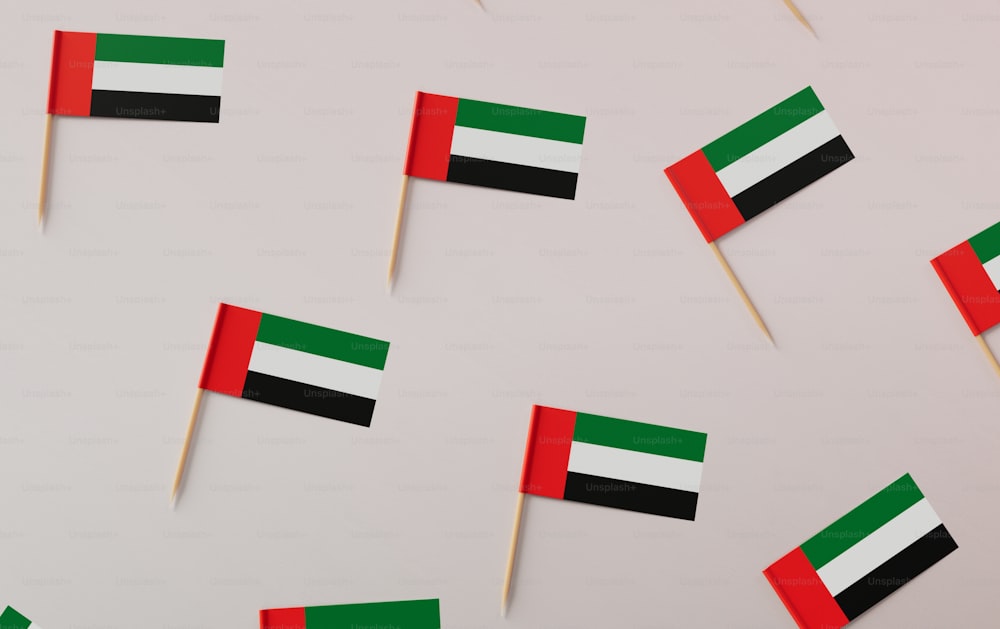 a group of small flags on toothpicks on a white surface