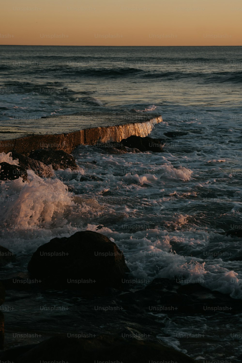 a body of water with waves coming in to shore