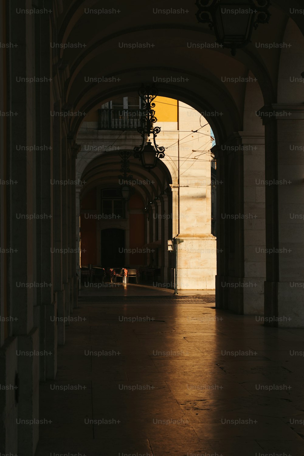 a person is walking down a hallway in a building