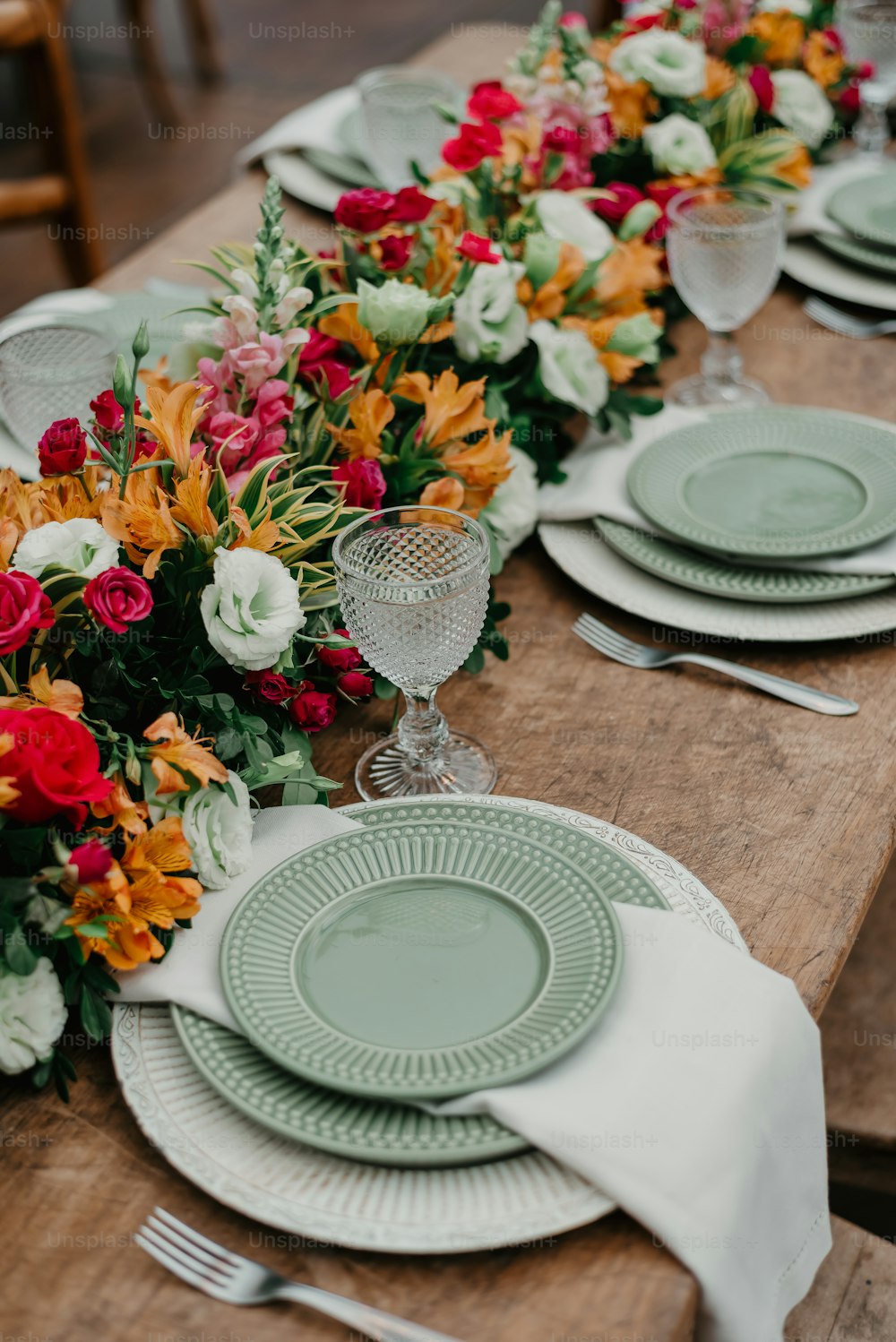 un tavolo di legno sormontato da piatti e fiori