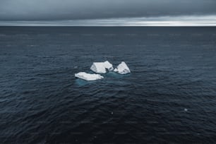 a group of icebergs floating on top of a body of water