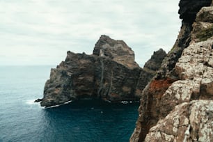 a large rock outcropping in the middle of the ocean