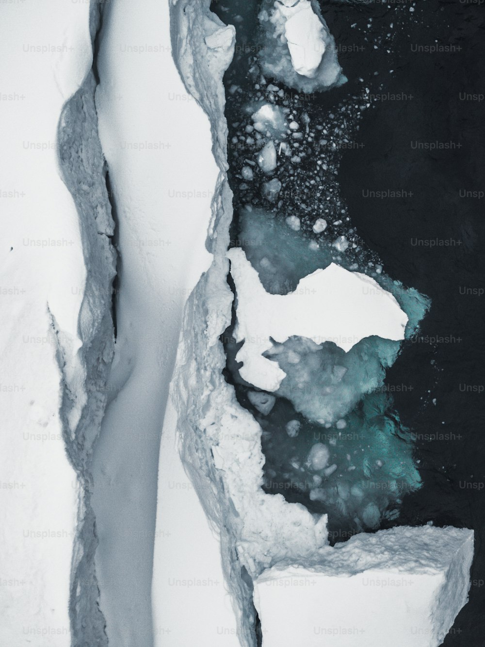 an aerial view of ice and water in the snow