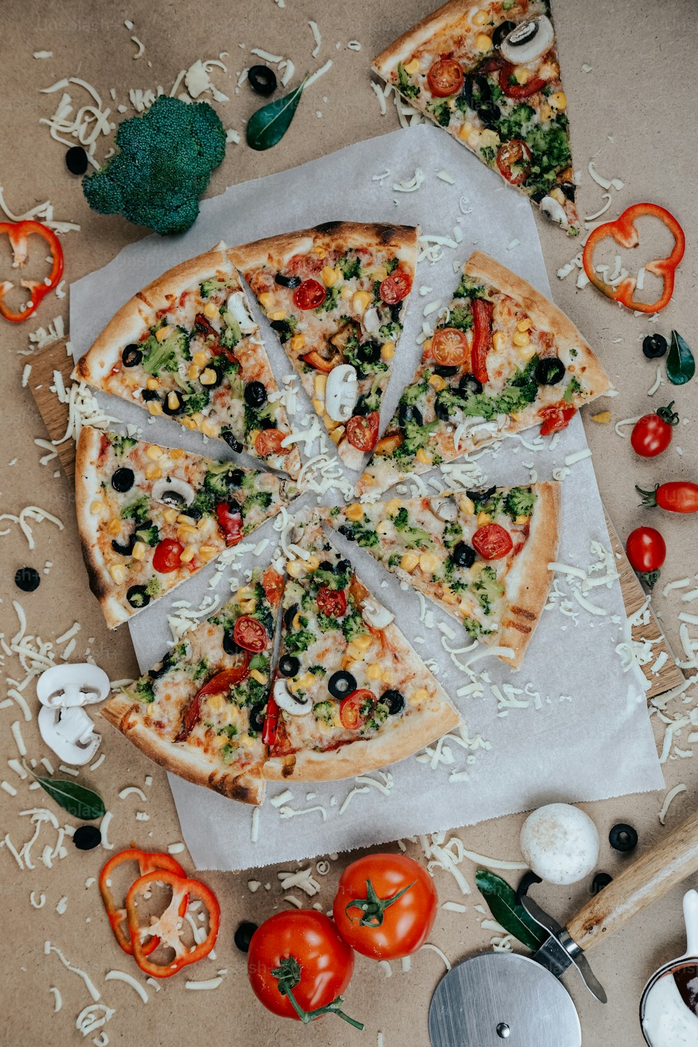 a pizza sitting on top of a table covered in toppings