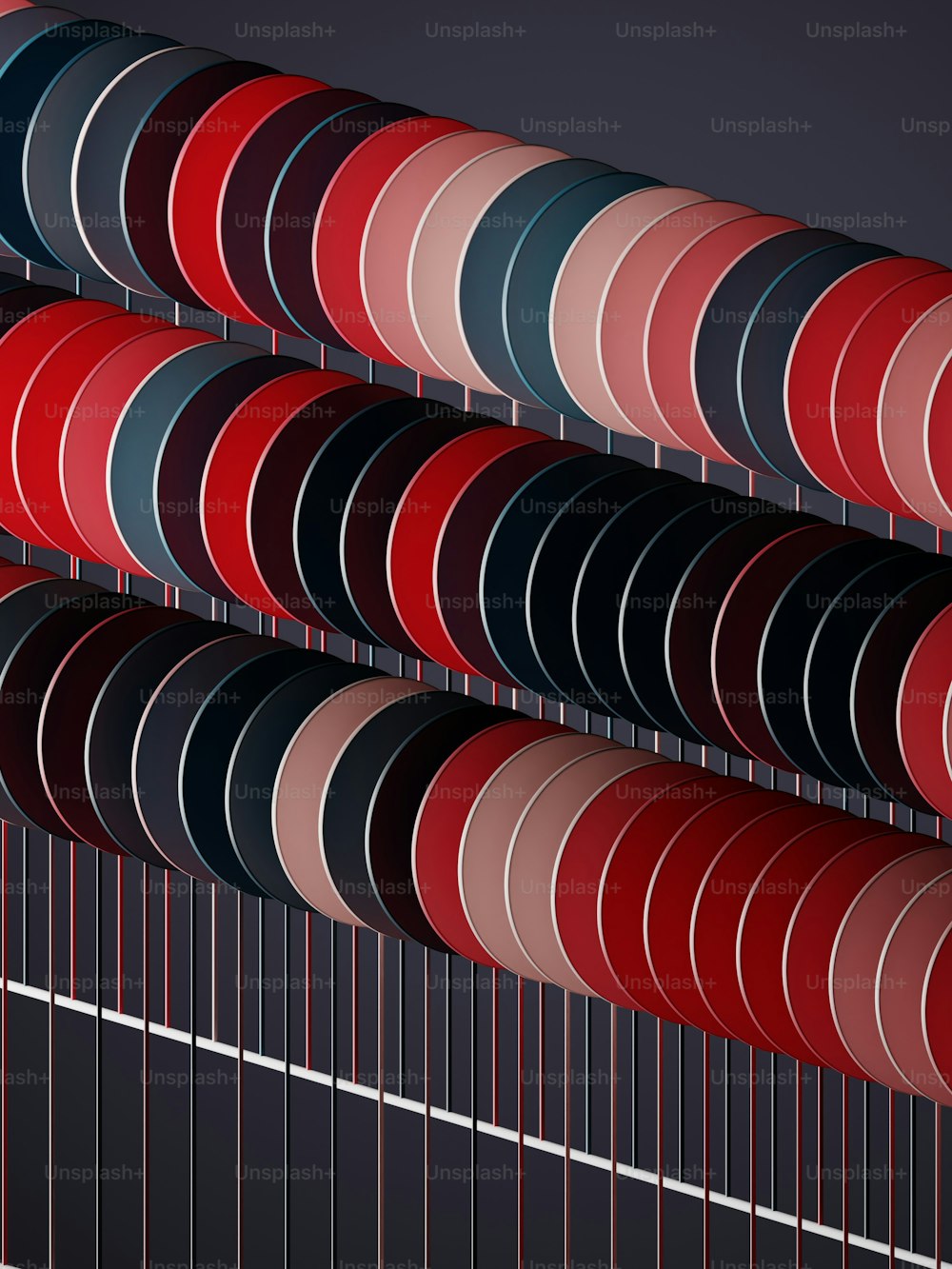 a group of red, black, and blue circles hanging from a metal rod