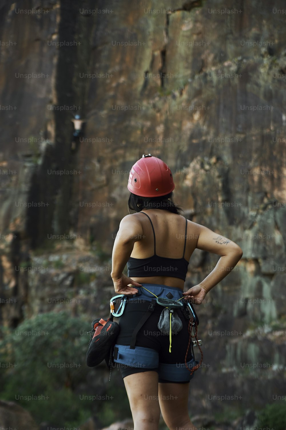 a woman wearing a helmet and climbing gear