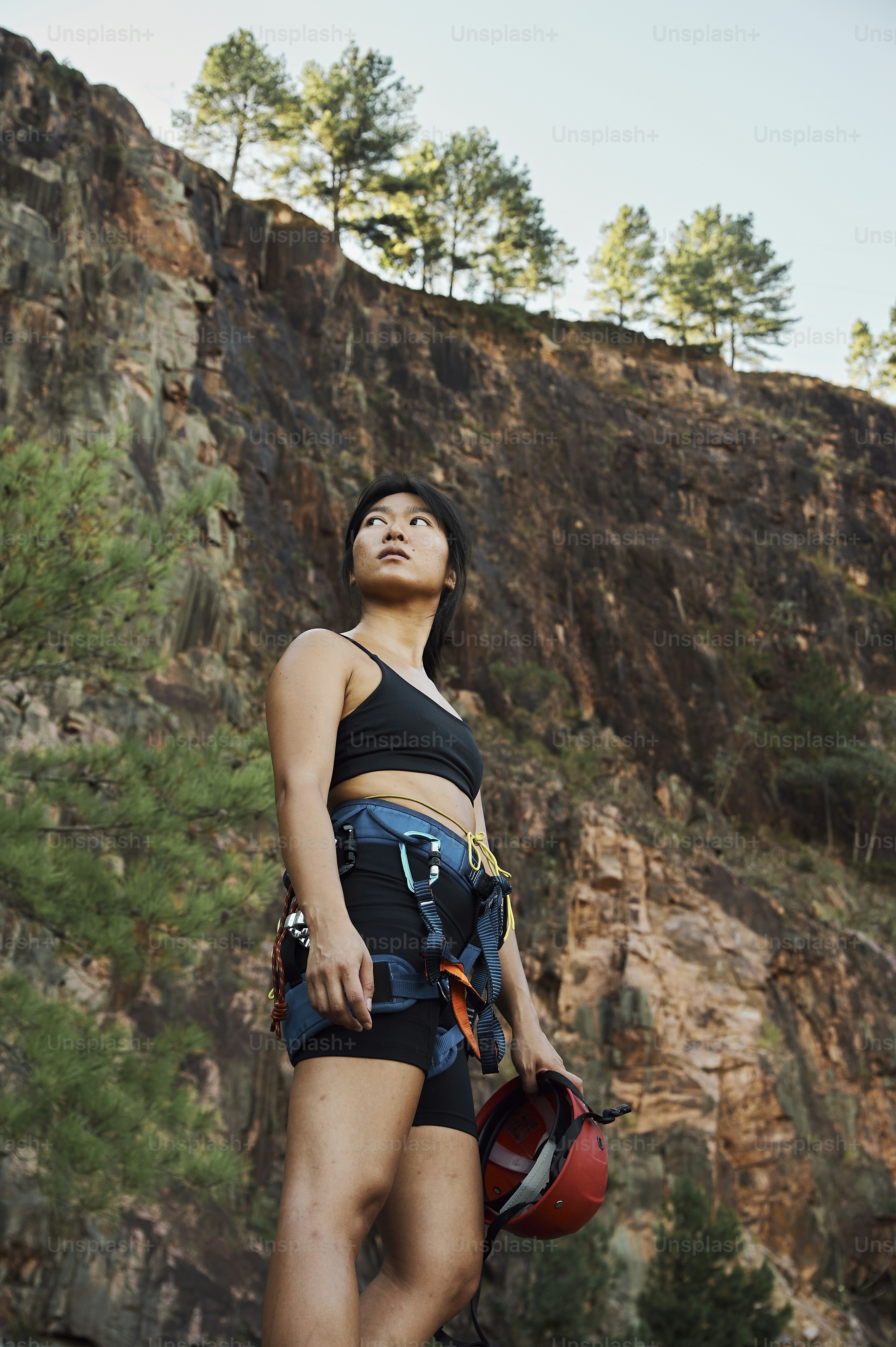 a woman in a black top and a red helmet