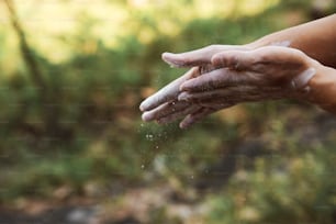 a person holding out their hands with soap on them