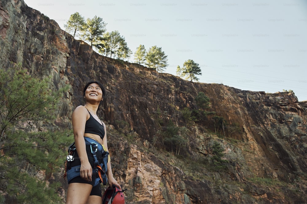 a woman standing in front of a cliff