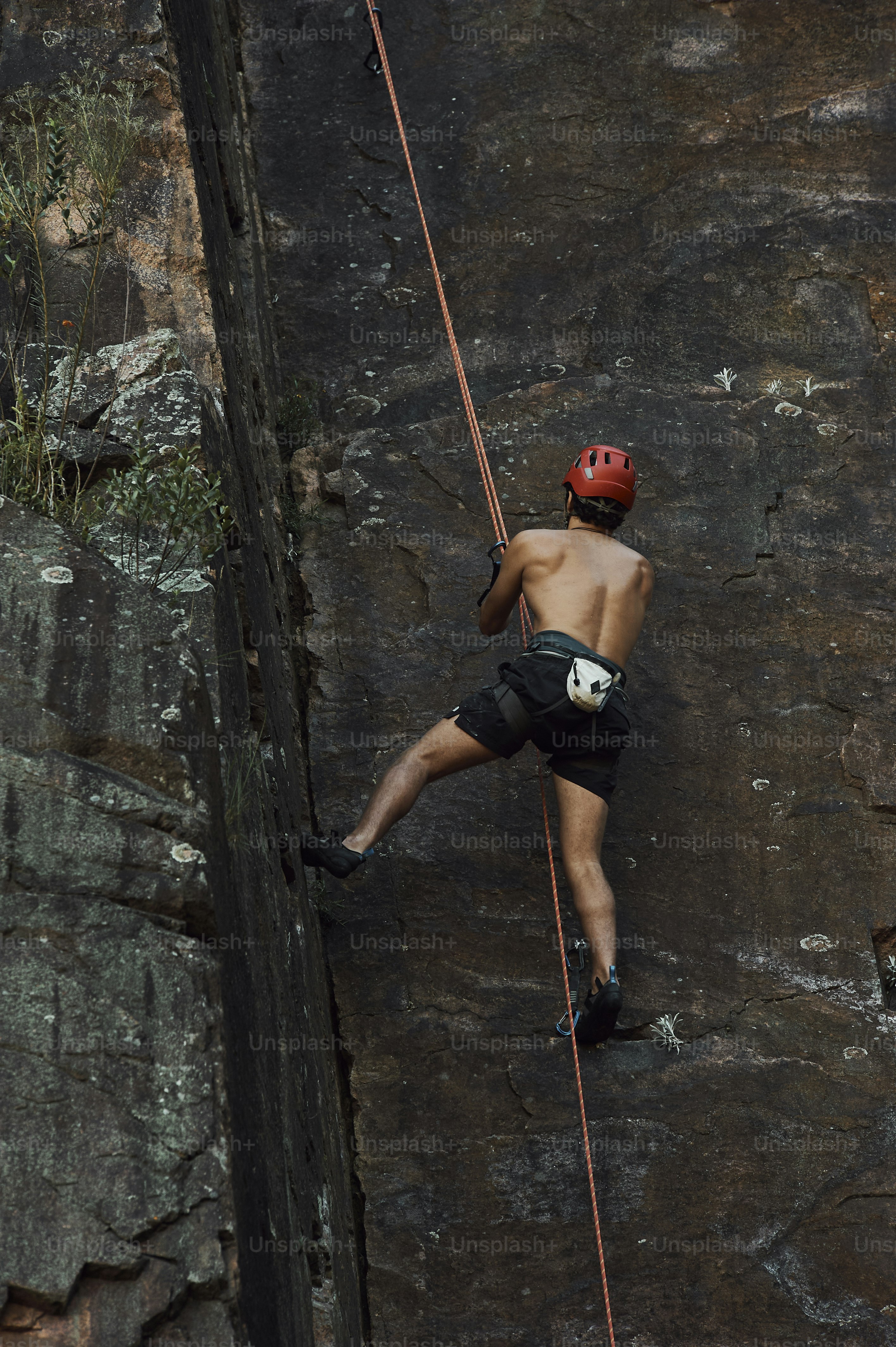 A man climbing up the side of a mountain photo – Climbing Image on Unsplash