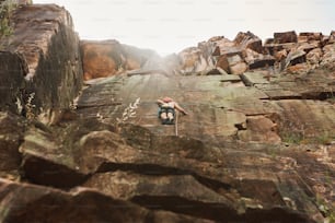 a man climbing up the side of a mountain