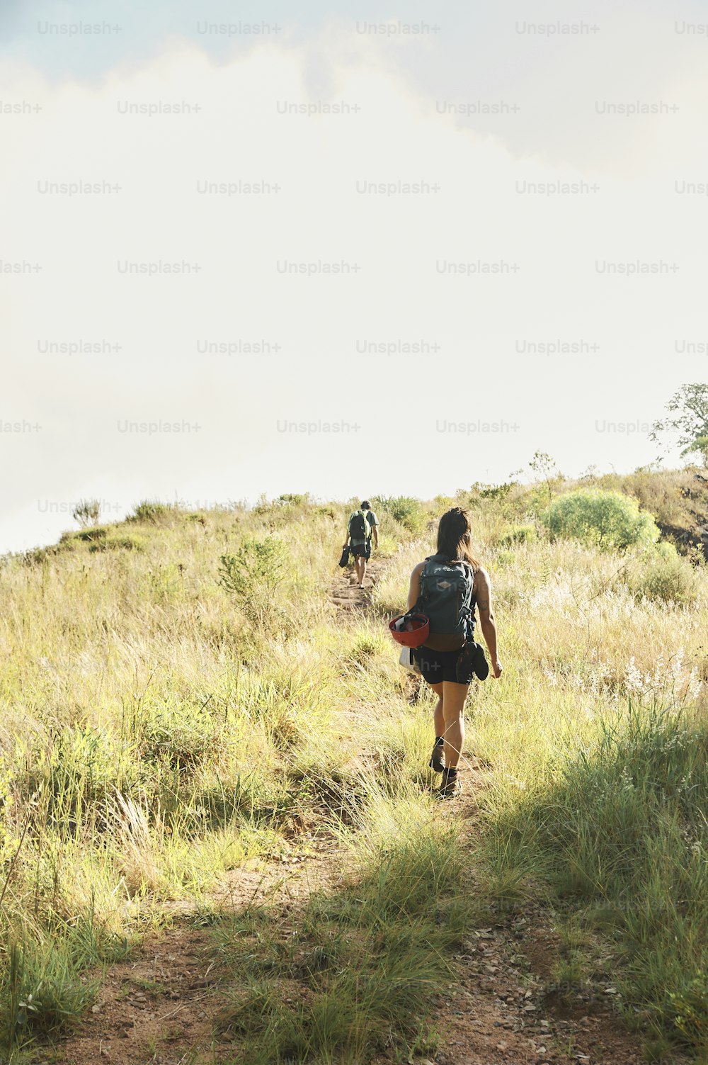 a group of people hiking up a hill