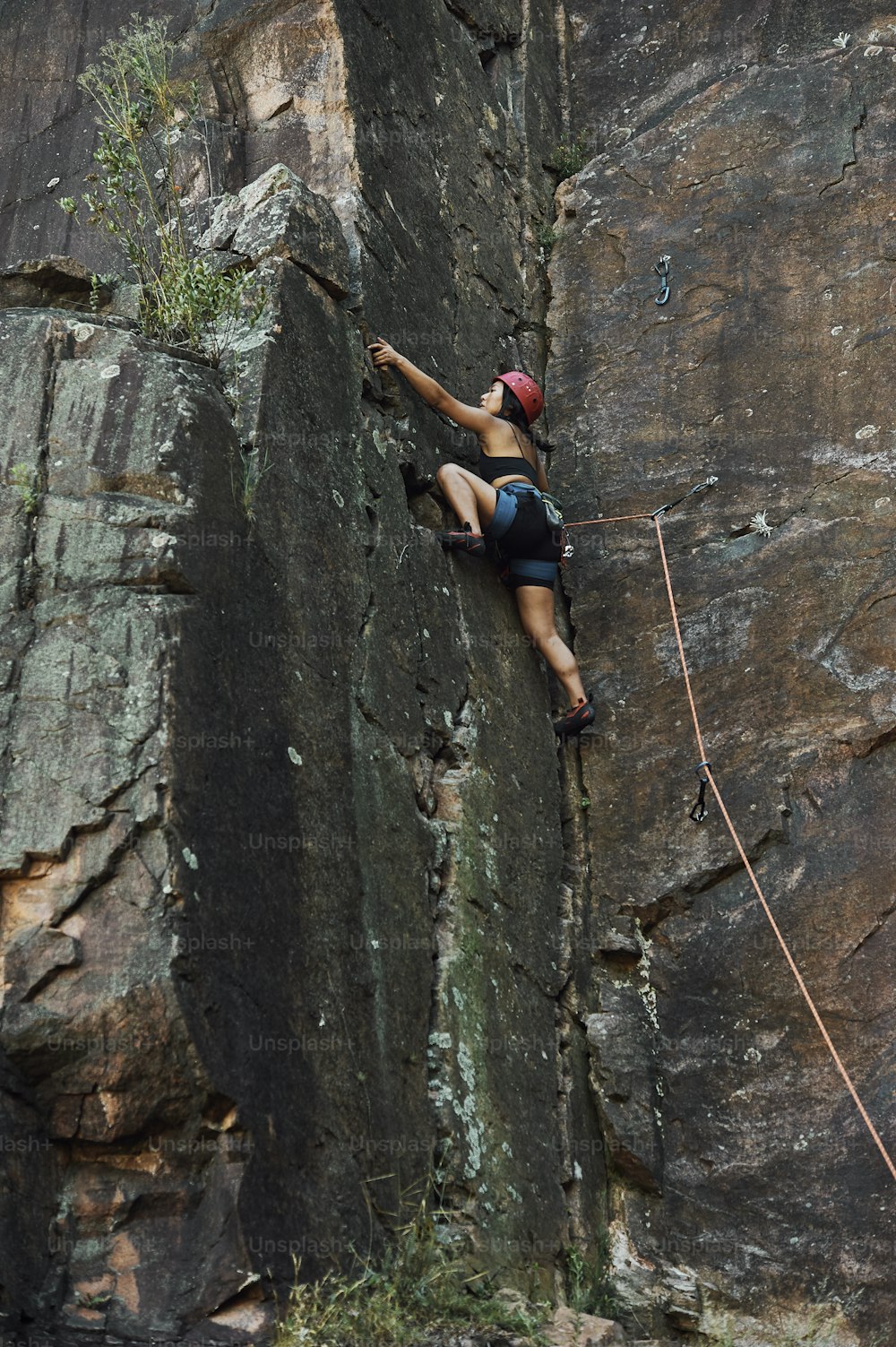 a man climbing up the side of a cliff