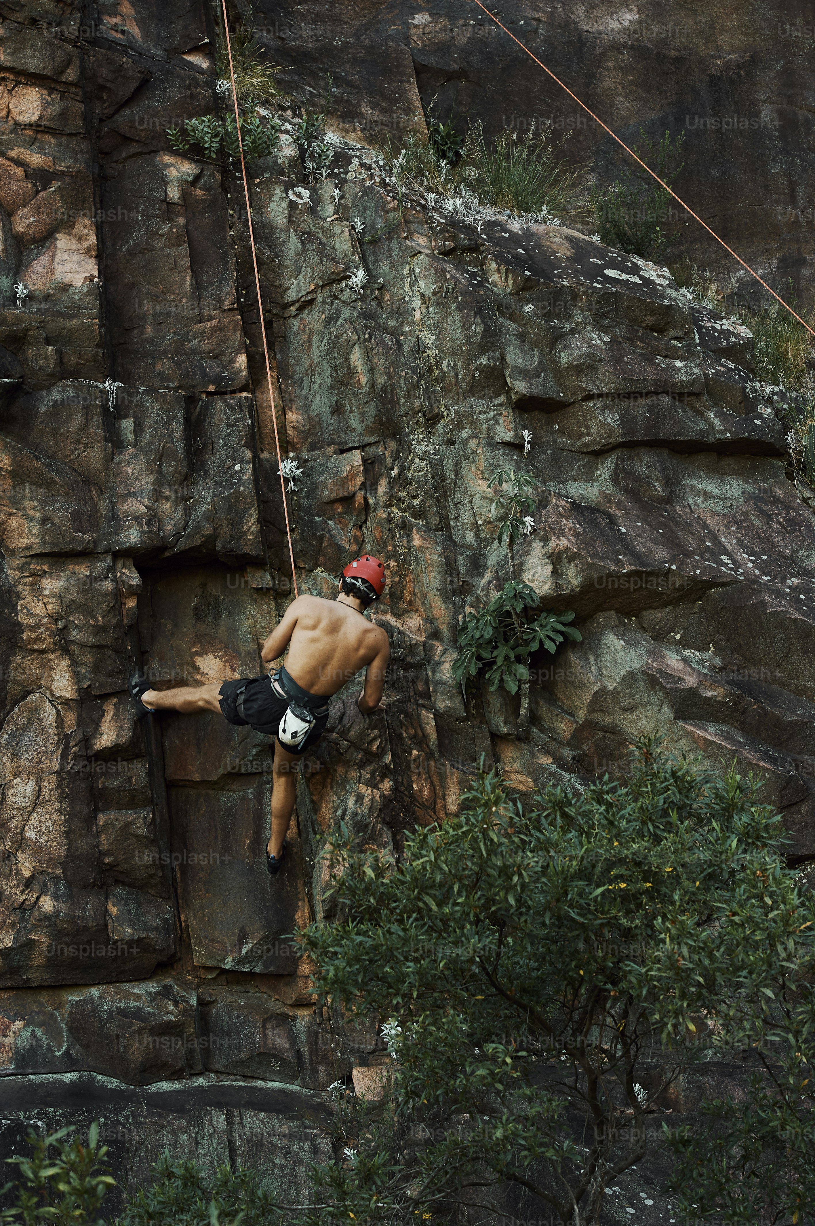 A man climbing up the side of a mountain photo – Climbing Image on Unsplash