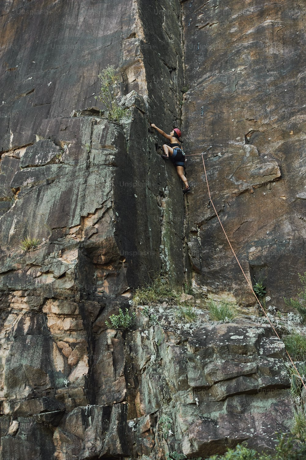 a man climbing up the side of a cliff