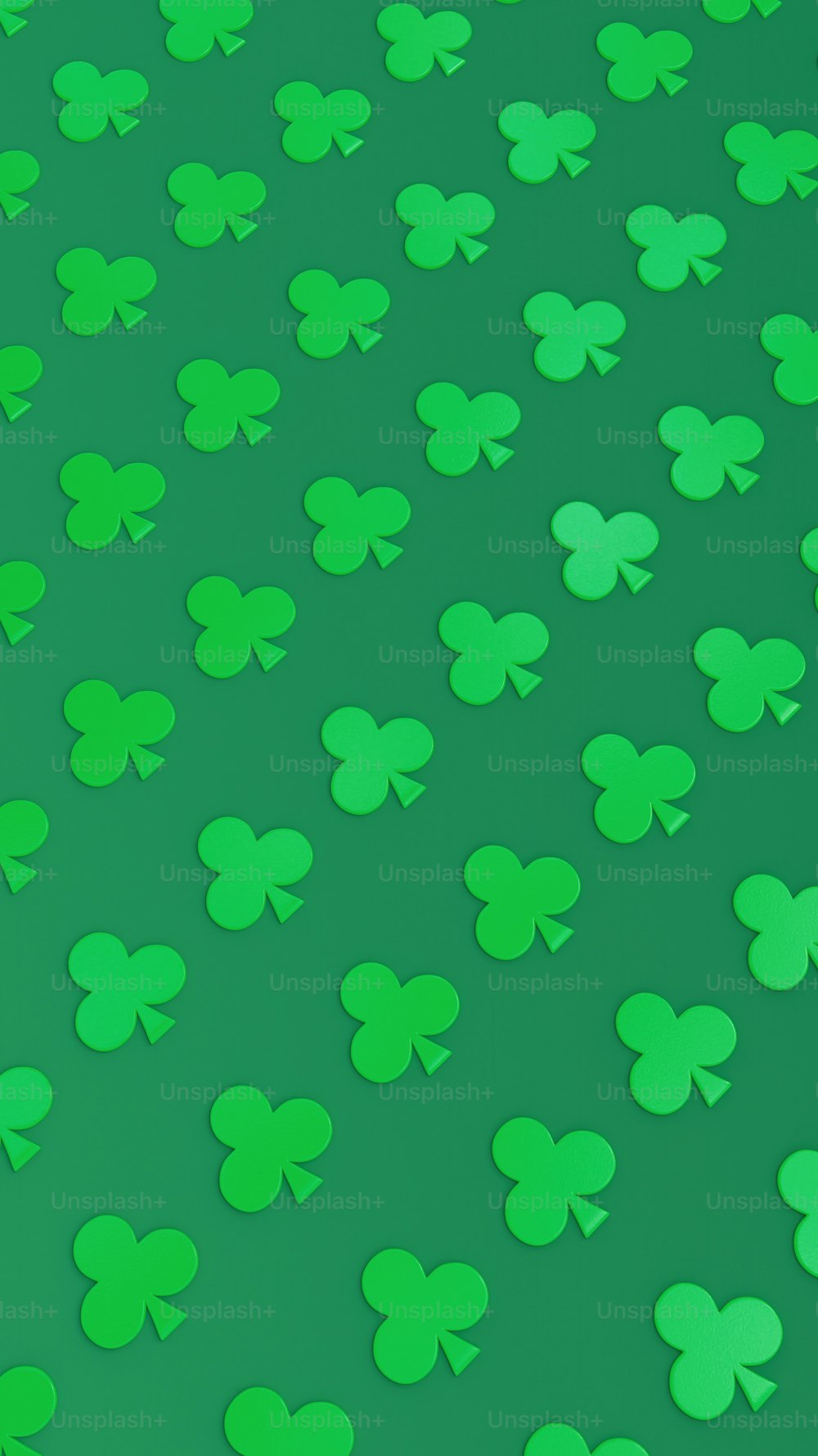 a lot of green shamrocks on a green background