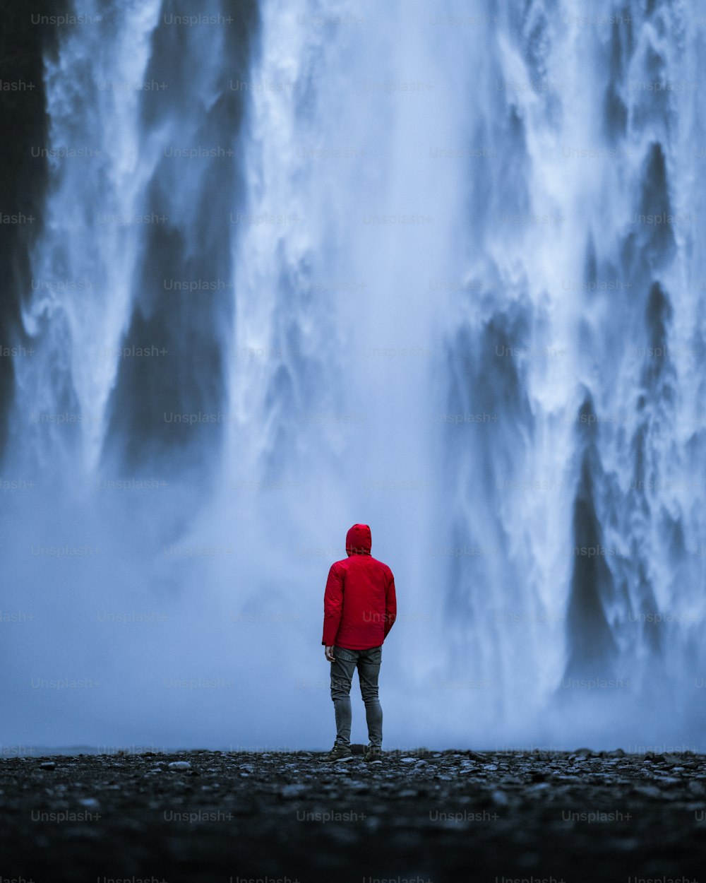 a person standing in front of a waterfall