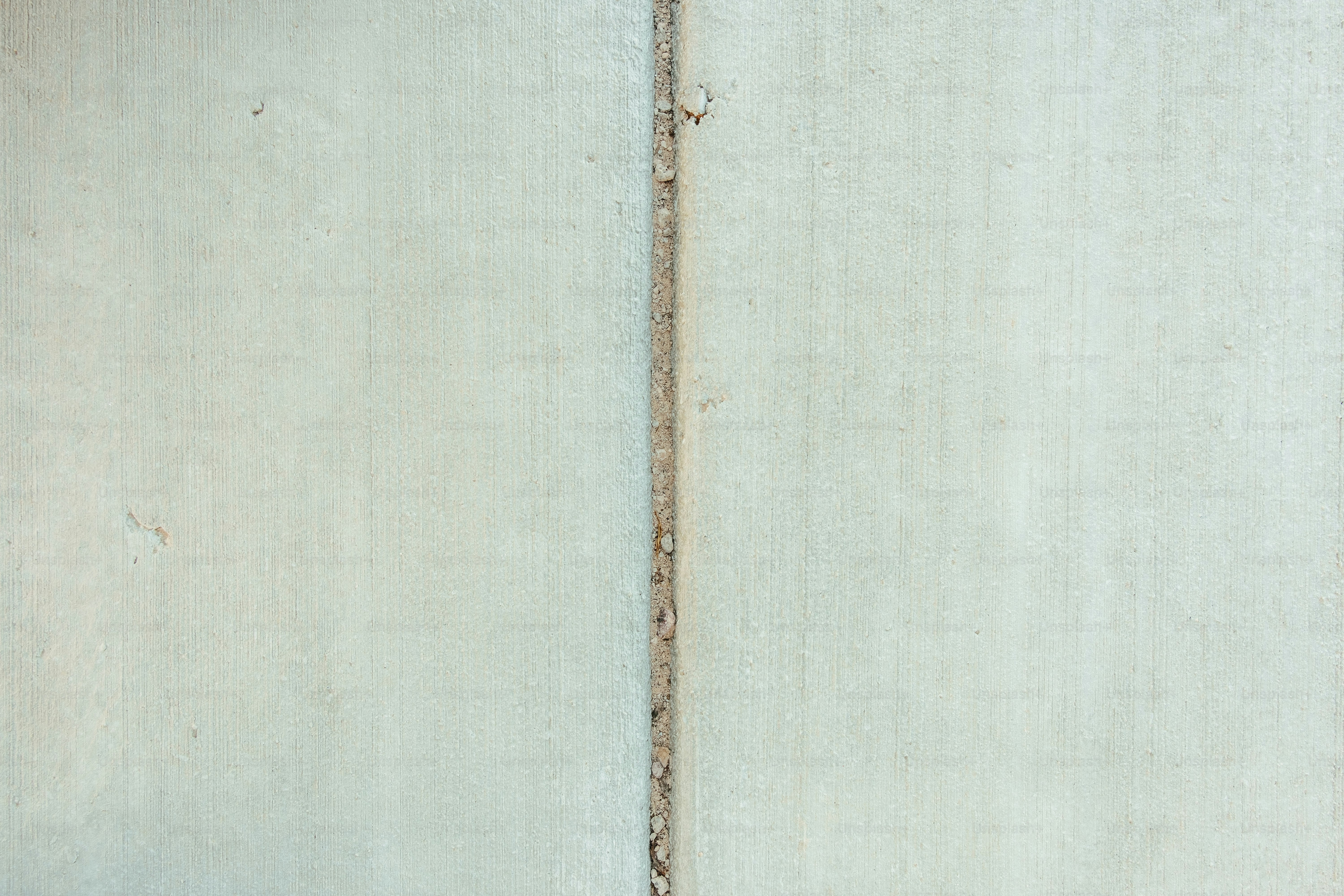 a red fire hydrant sitting next to a white wall