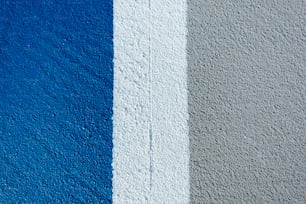 a blue and grey wall with a white stripe