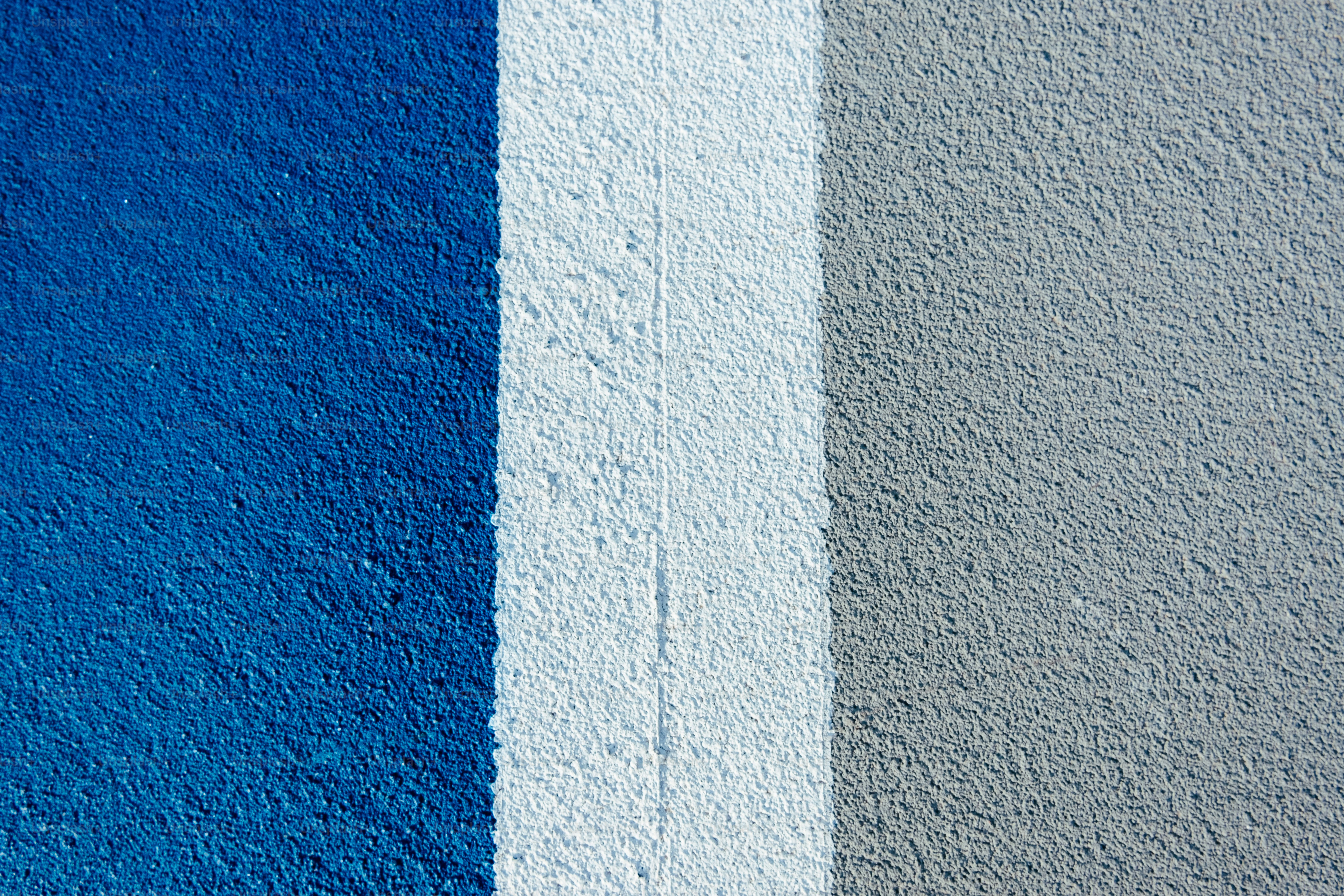 a blue and grey wall with a white stripe