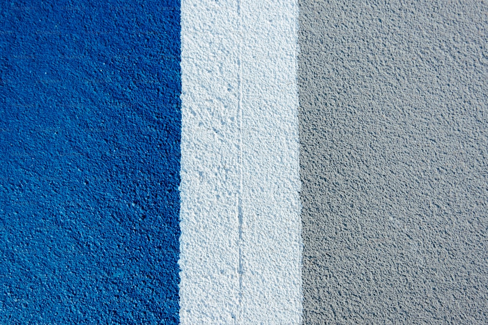 a blue and grey wall with a white stripe