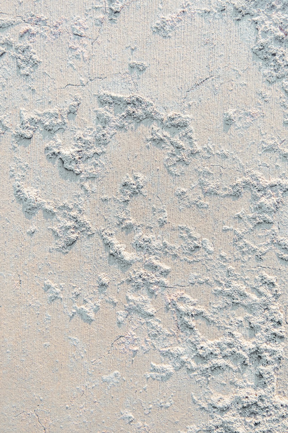 a close up of a white wall with some dirt on it