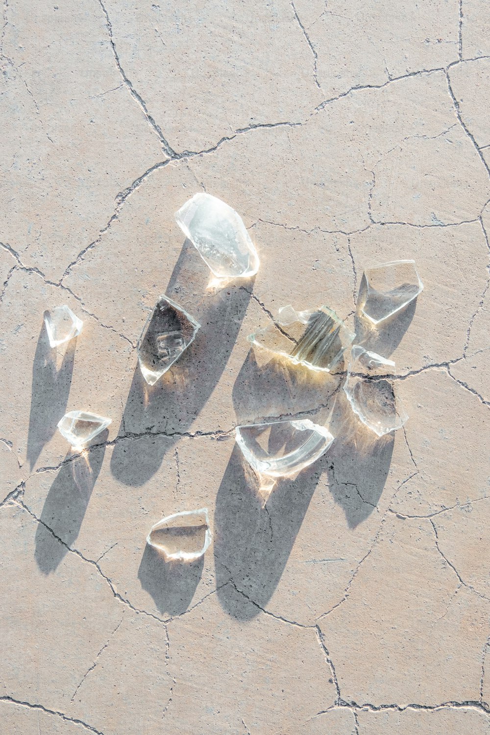 a group of rocks sitting on top of a cracked ground