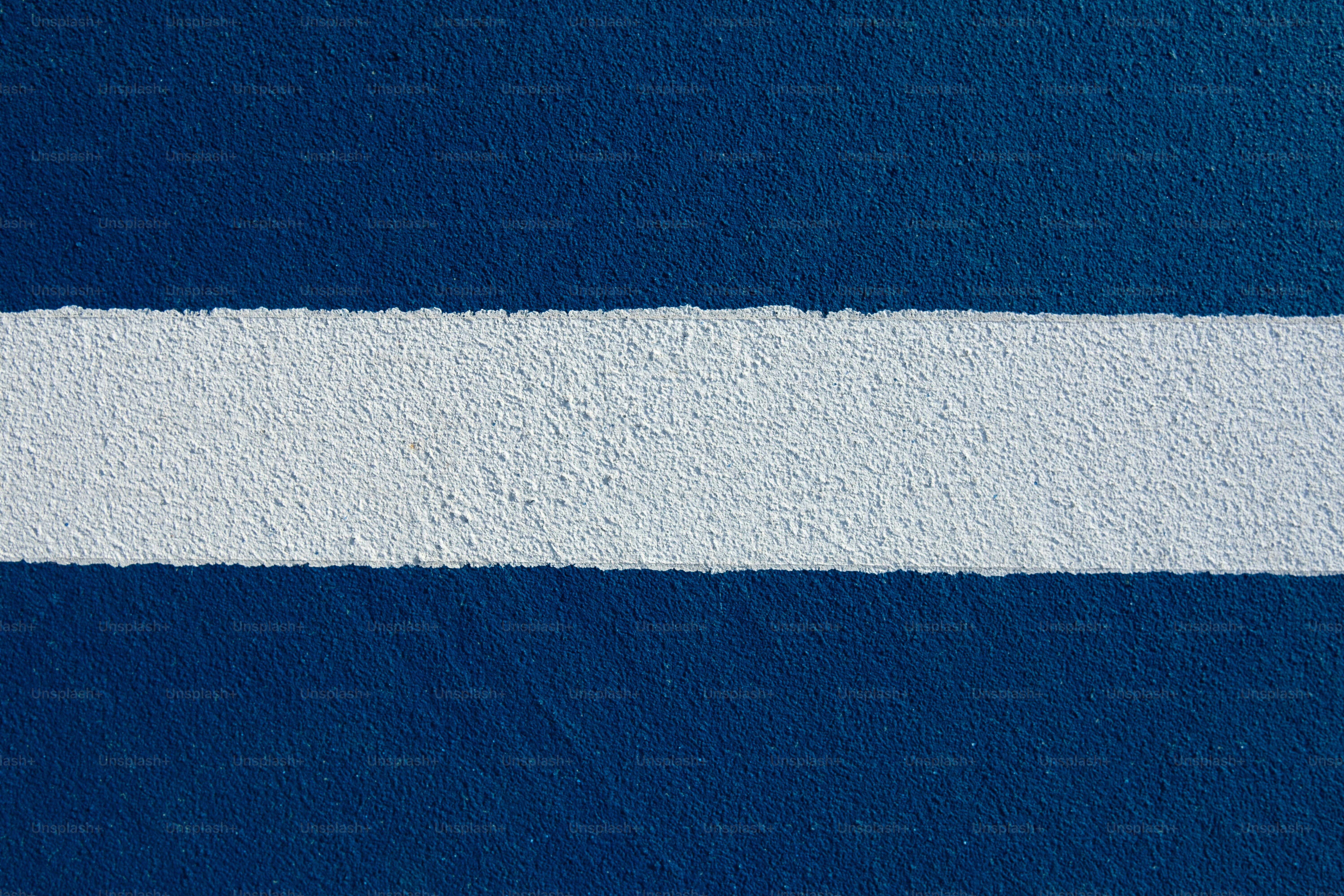 a blue and white wall with a white strip painted on it