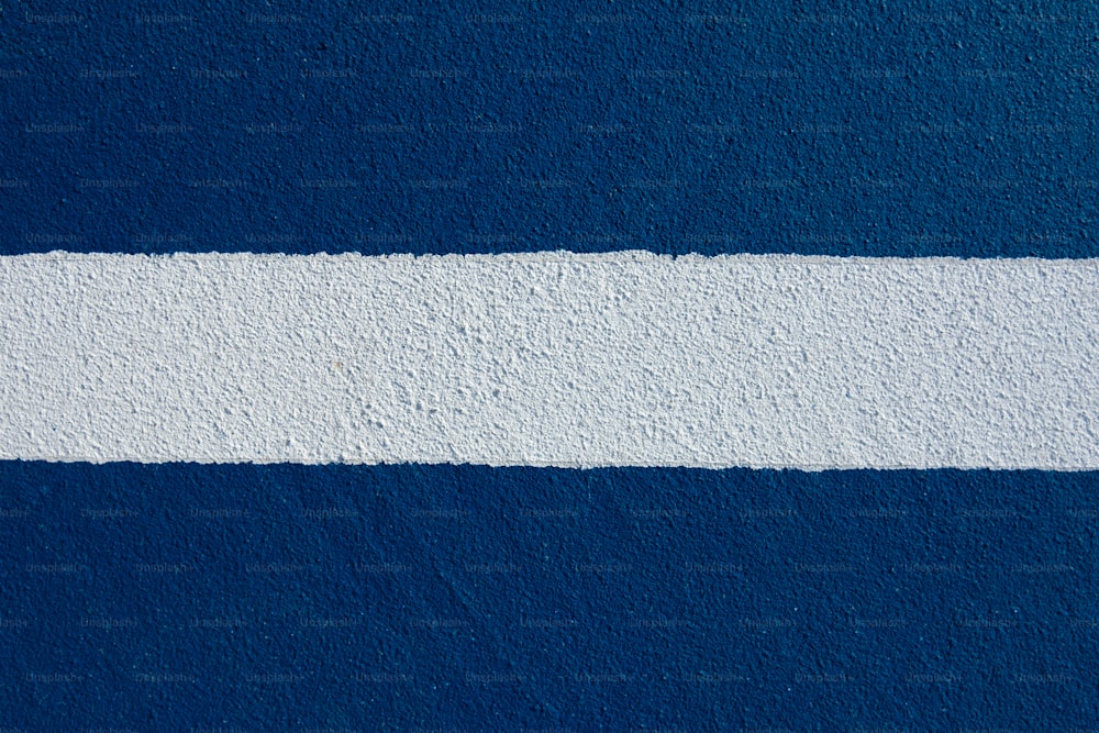 a blue and white wall with a white strip painted on it