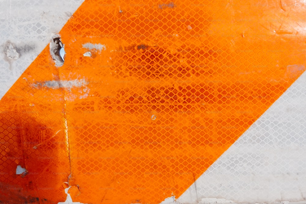 a close up of an orange and white sign