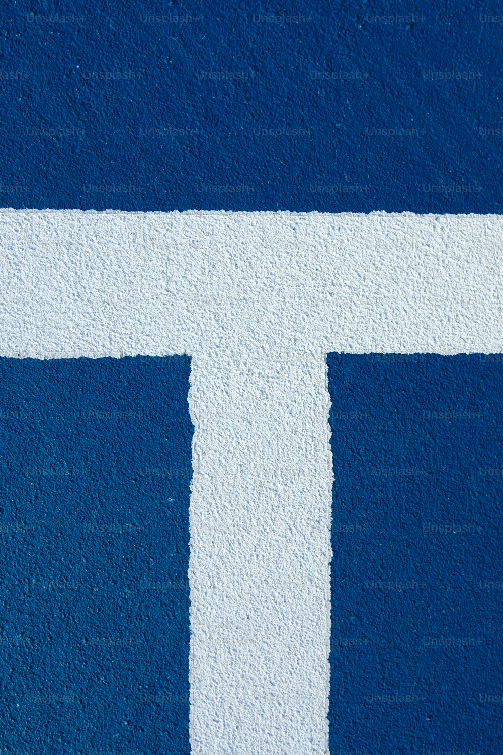 a white cross painted on a blue wall