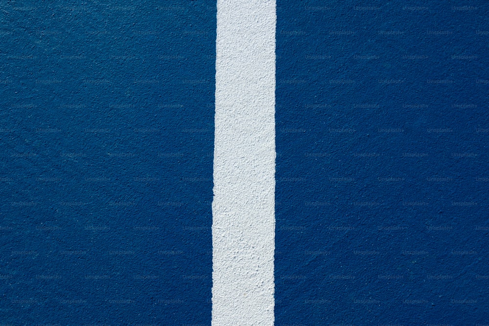 a white line painted on the side of a blue wall