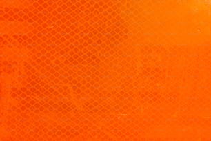 a close up of an orange background with a grid pattern
