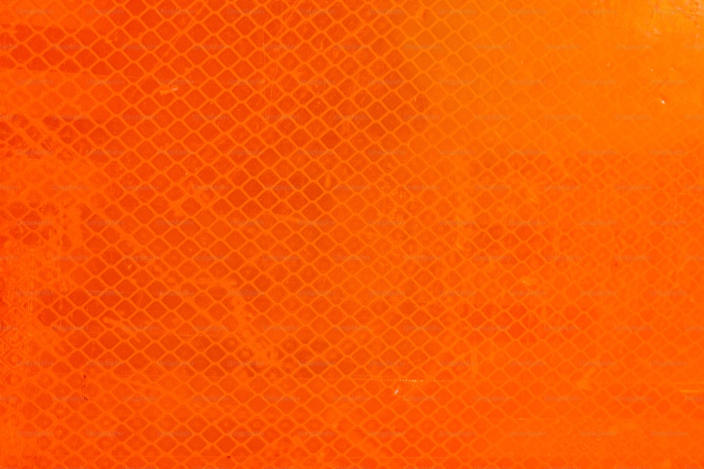 a close up of an orange background with a grid pattern