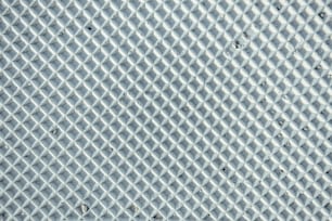 a close up of a metal surface with a diamond pattern