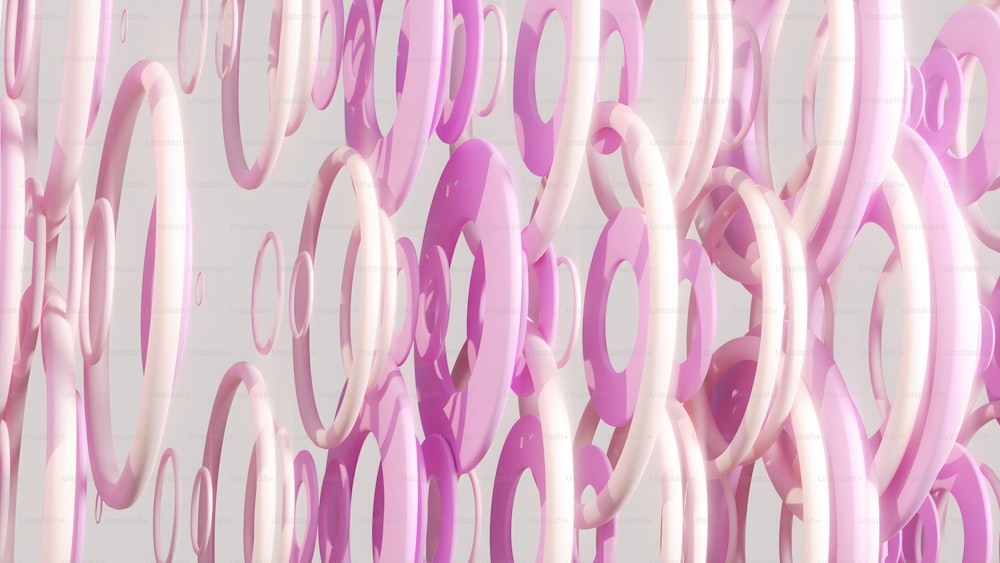 a group of pink and white rings hanging from a wall