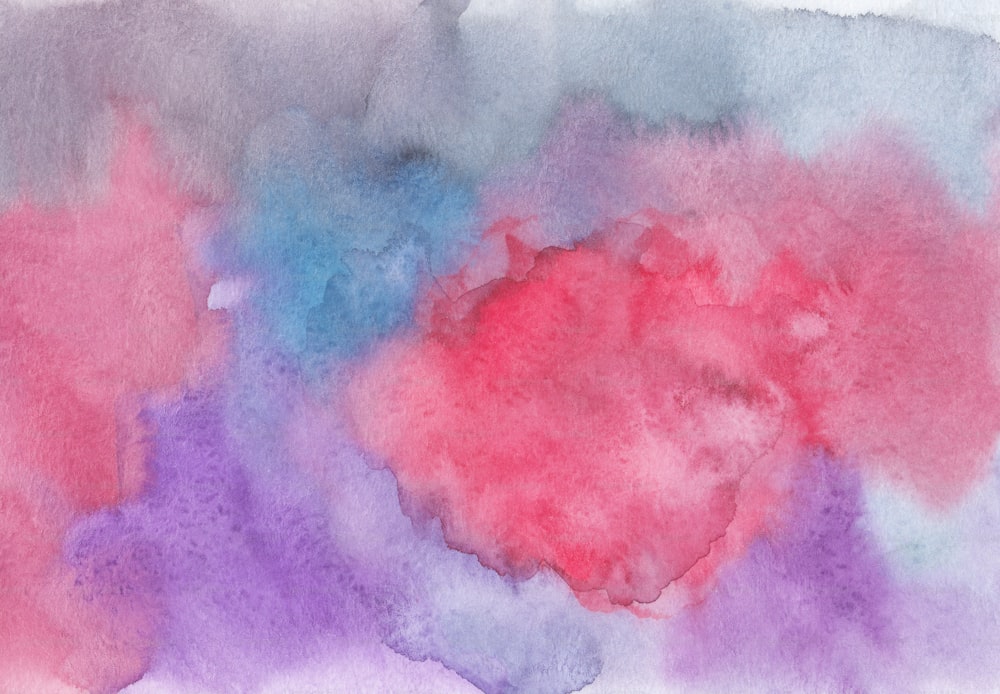 a watercolor painting of pink, blue, and purple colors