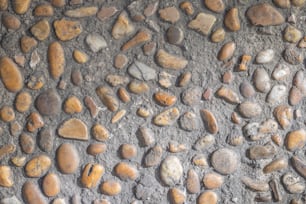 a close up of rocks and gravel on a wall
