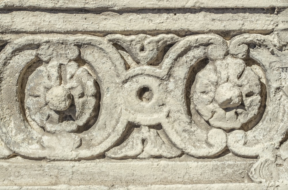 a close up of a stone carving on a building