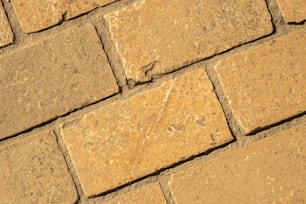 a close up of a yellow brick wall